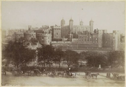 View of the Tower of London with horse-drawn carriages in the foreground