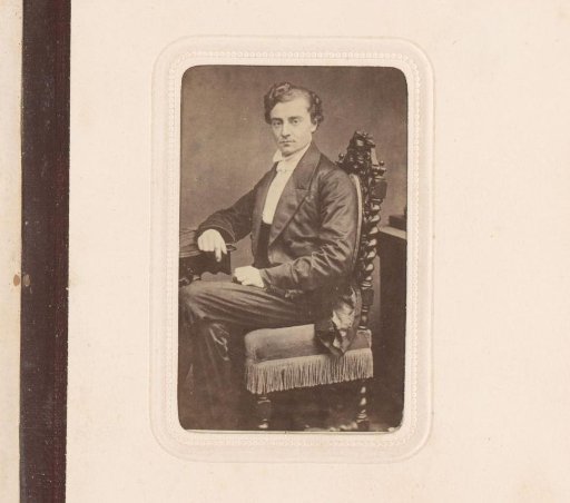 Portrait of a man, seated at a table