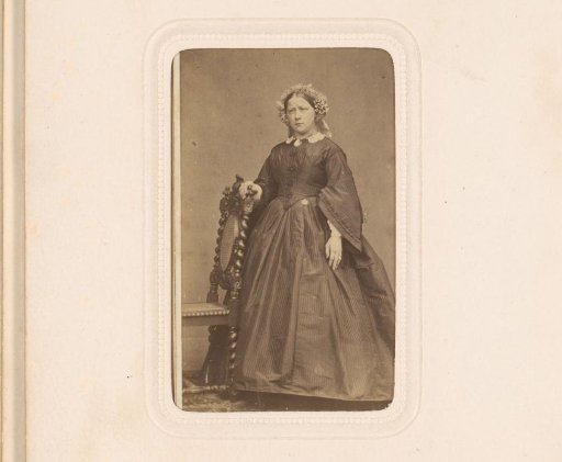 Portrait of a young woman with cap, standing by a chair, inscribed as N. Dijserinck
