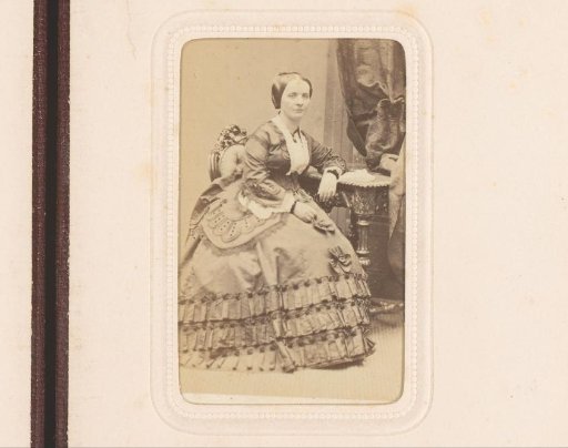 Portrait of a woman, seated at a table