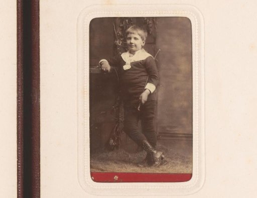 Portrait of a standing boy with riding whip in hand