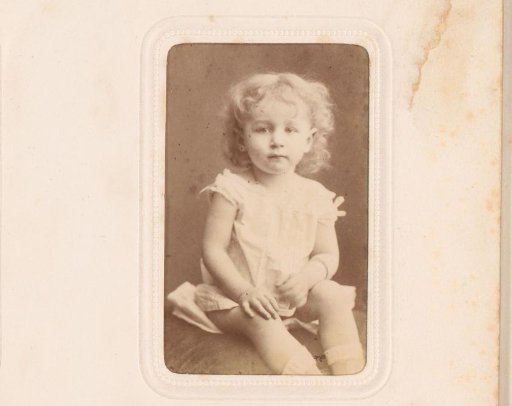 Portrait of a seated girl in white dress