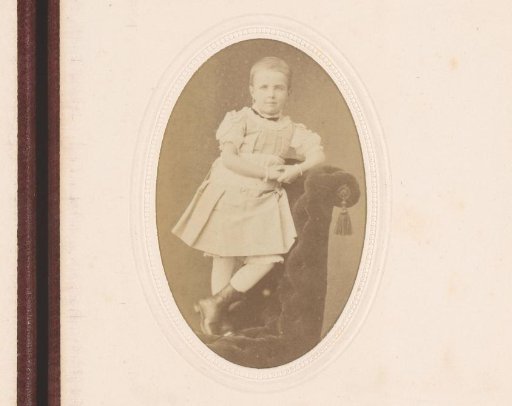 Portrait of a girl, standing on an armchair