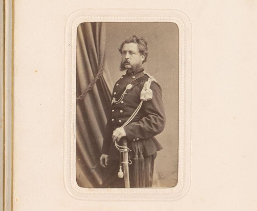Portrait of a standing man in military uniform with a sabre