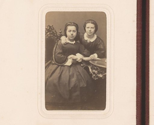 Portrait of two women, seated at a table
