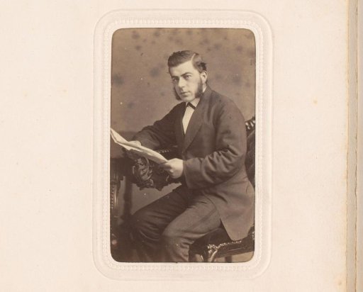 Portrait of a seated man with papers in his hand