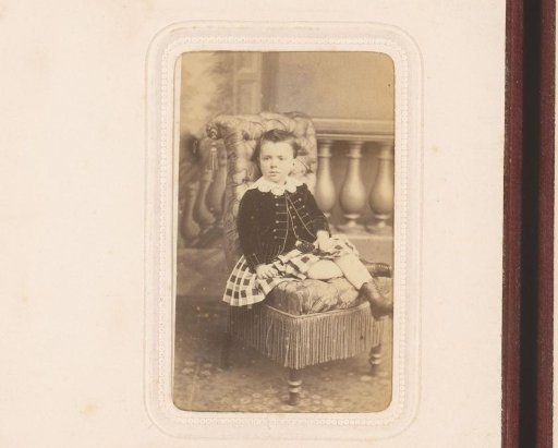 Portrait of a seated girl in a checked skirt