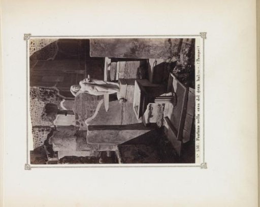 Remains of a house in Pompeii with a statue and a fountain
