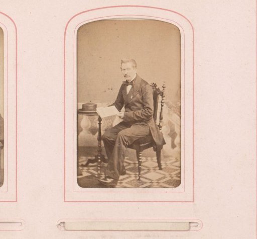 Portrait of a seated man with a book