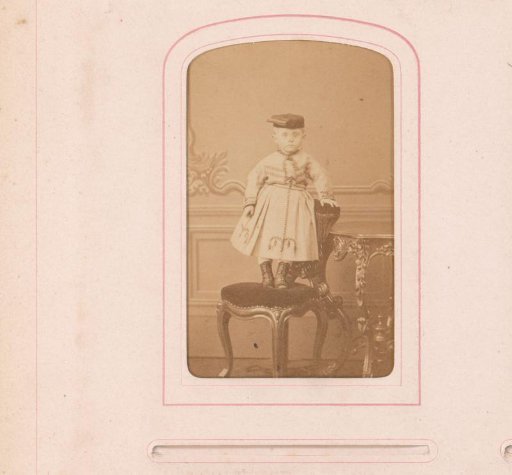 Portrait of a child standing on a chair