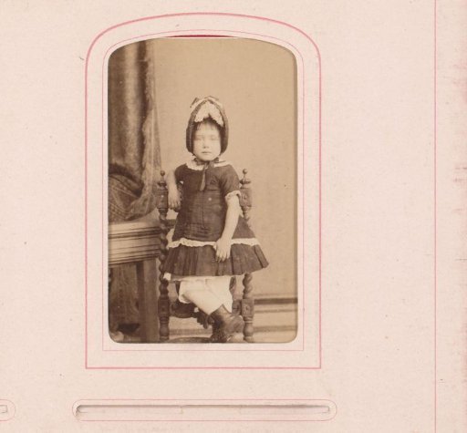 Portrait of a child standing on a chair
