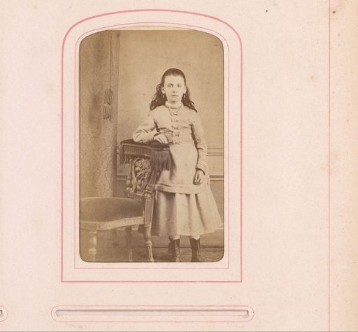 Portrait of a girl leaning against a chair