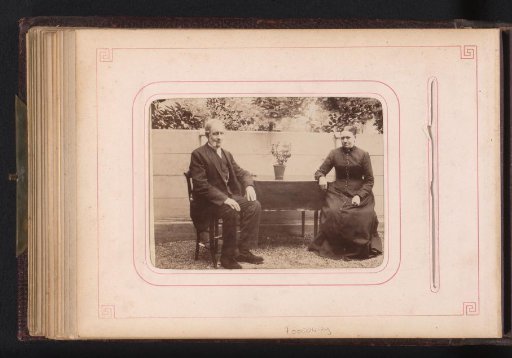 Man and woman seated at a table in a garden
