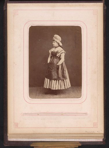 Portrait of a standing woman in a striped dress