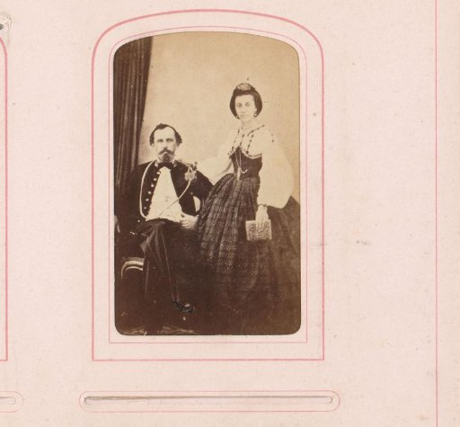 Portrait of a standing woman with album and seated man in uniform