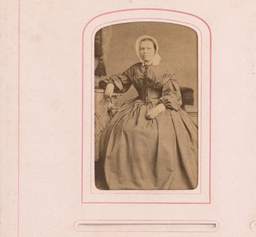Portrait of a seated woman with cap