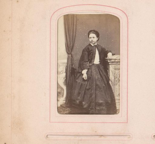 Portrait of a standing girl by a pedestal
