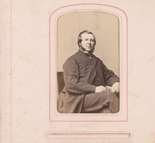 Portrait of a seated man with sideburns