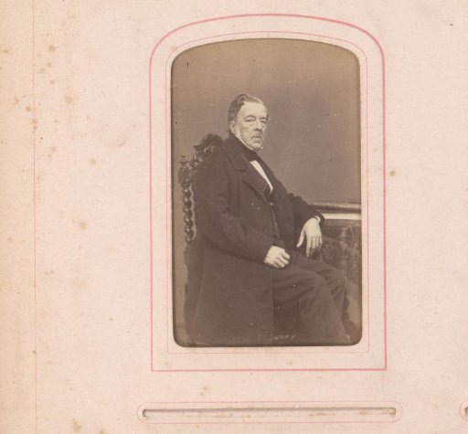 Portrait of a man seated at a table