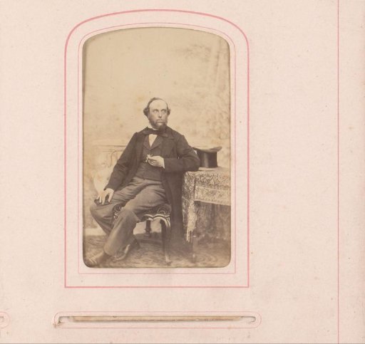 Portrait of Bastiaan de Greef sitting with a cigar