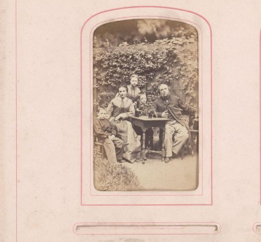 Group portrait of Bastiaan de Greef with wife and three children around a table in a garden
