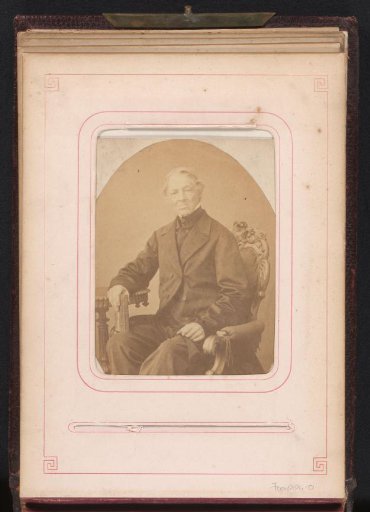 Portrait of a seated man with a book