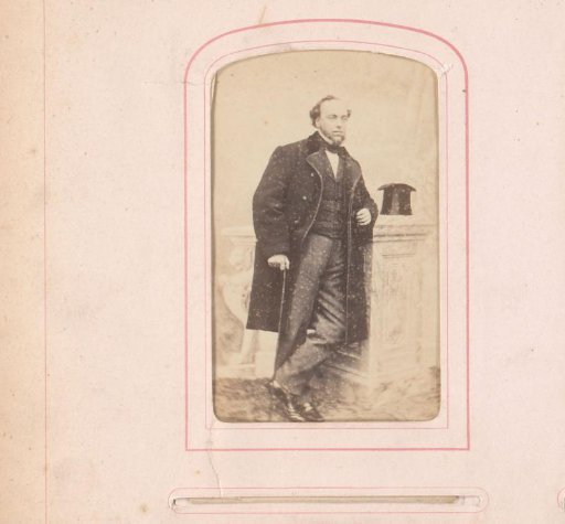 Portrait of Bastiaan de Greef standing by a pedestal with hat and cane