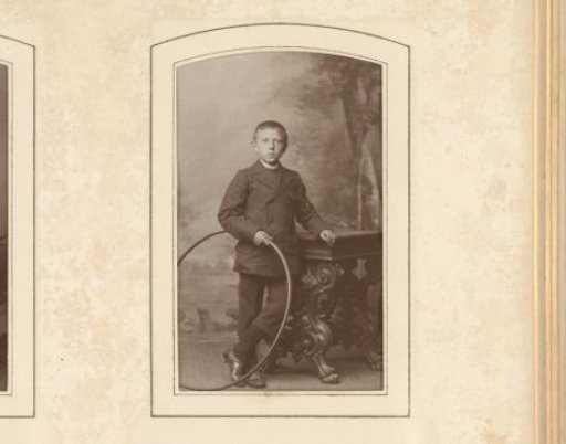 Portrait of a Boy with a Hoop in His Hand, Standing by a Table