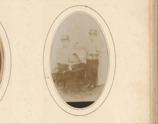Portrait of two boys with a wheelbarrow