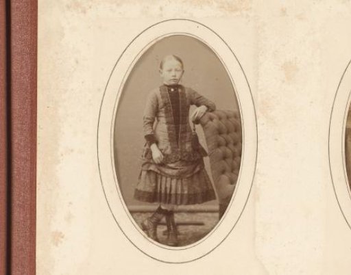 Portrait of a standing girl by an armchair, designated as Saakje Anema