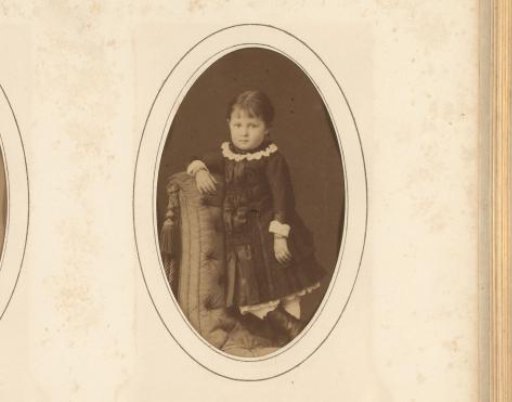 Portrait of a girl standing on a chair
