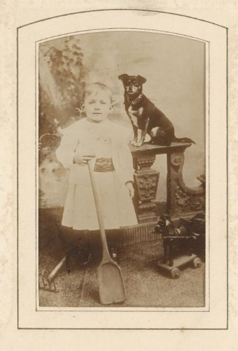 Portrait of a girl holding a spade and a dog on a balustrade