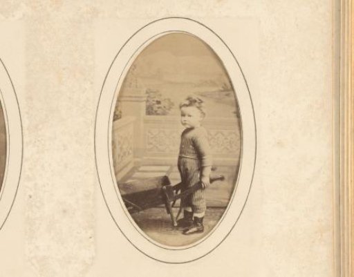 Portrait of a standing boy with a wheelbarrow