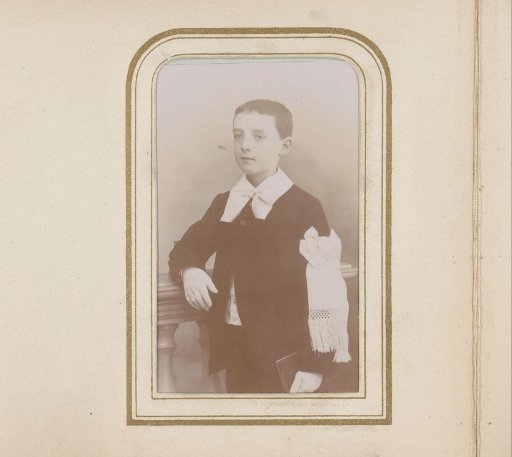 Portrait of a boy with a white ribbon on his arm