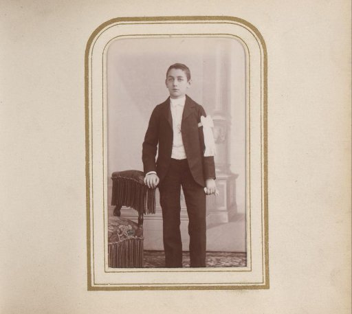 Portrait of a boy with a white ribbon on his arm