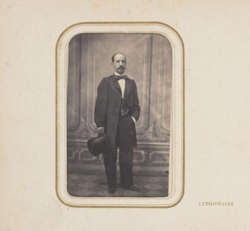 Portrait of a man holding a tall hat