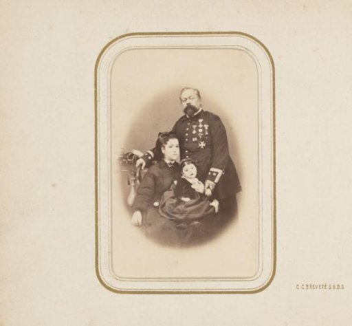 Portrait of a man in uniform with a woman and child