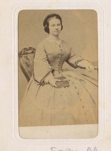 Portrait of a seated young woman with a book in her hand