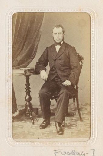 Portrait of a seated man at a table
