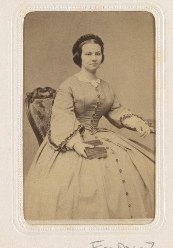 Portrait of a seated young woman with a book in her hand