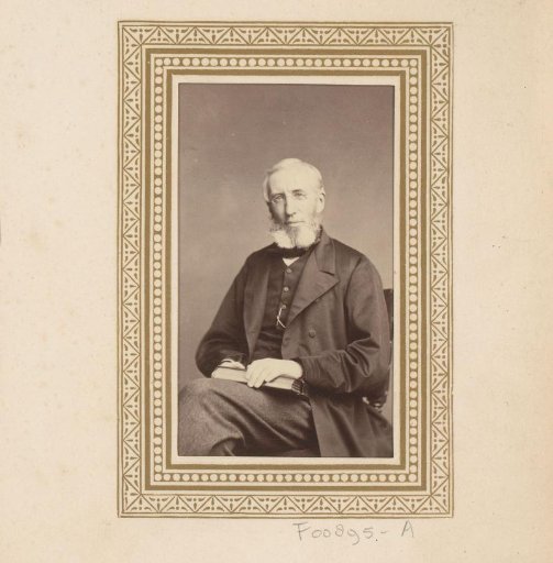 Portrait of a man with a book or album on his lap
