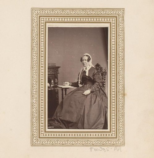 Portrait of a woman seated at a table