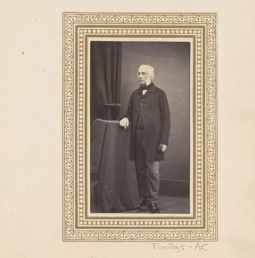 Portrait of a man with a tall hat on a table beside him
