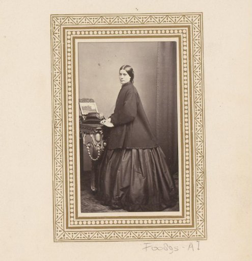 Portrait of a standing woman by a table