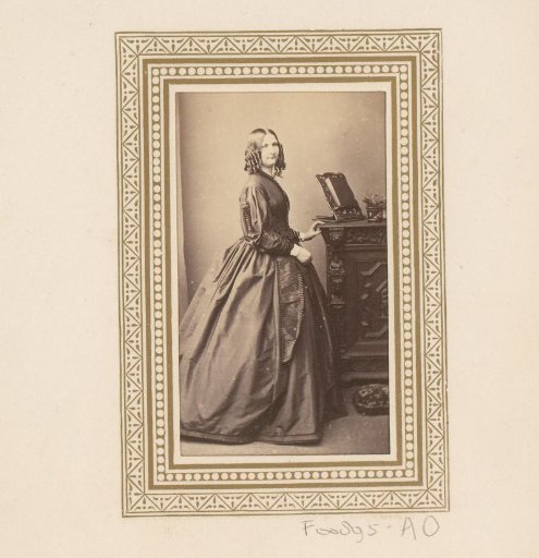 Portrait of a standing woman by a cabinet