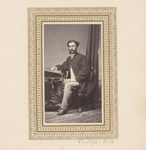 Portrait of a seated man at a desk