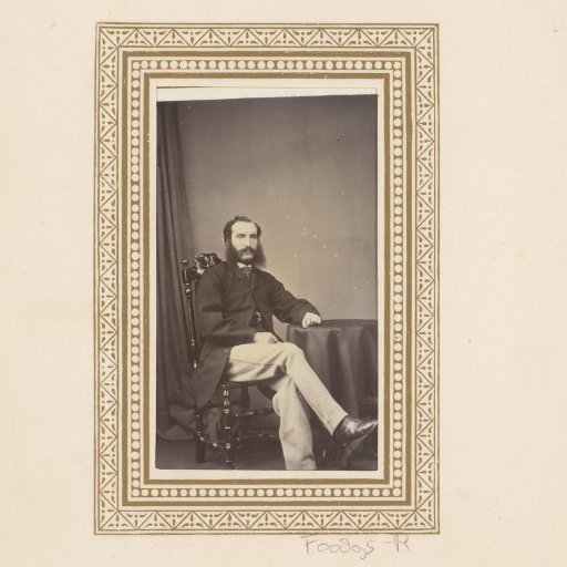 Portrait of a seated man with sideburns