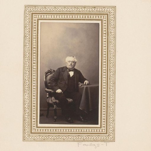 Portrait of a man, seated at a table