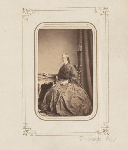 Portrait of a woman, seated at a table