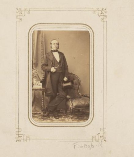 Portrait of a man with a tall hat in his hand